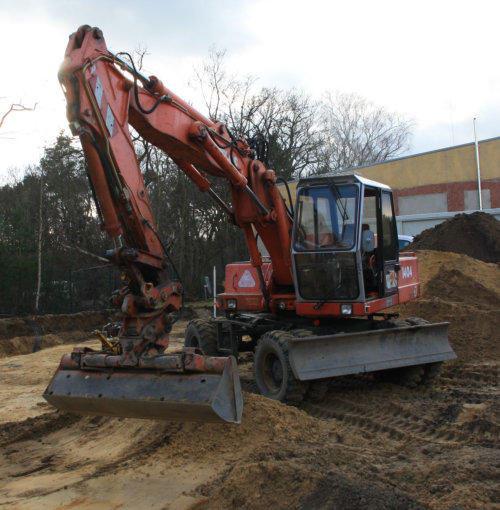 Bagger planiert Fläche