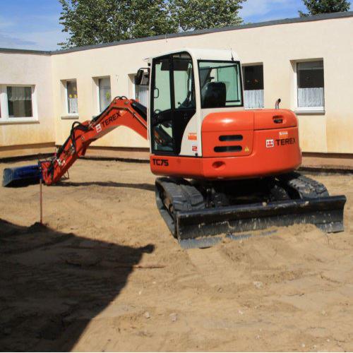 Bagger planiert Fläche